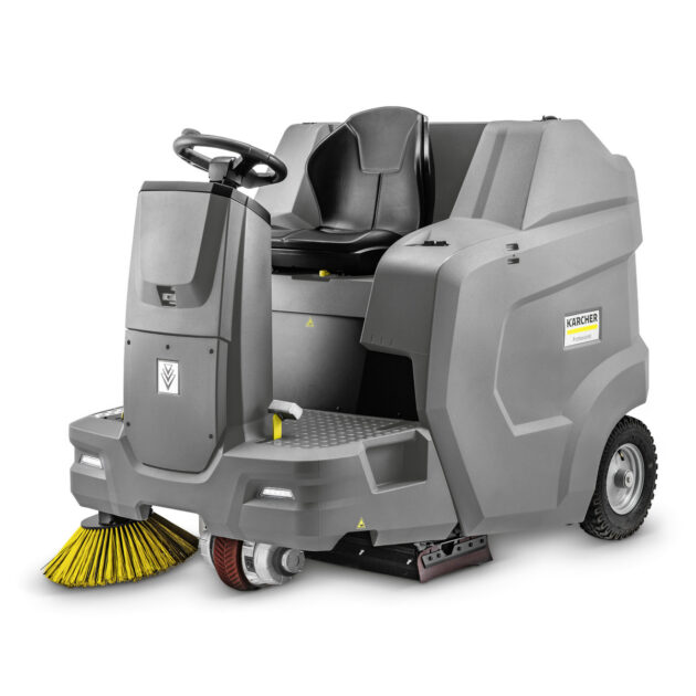 A Vacuum Sweeper KM 100/120 R BP Pack by kärcher, featuring a seat and a set of rotating brushes at the front, isolated on a white background.