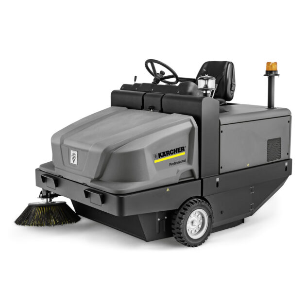 A Vacuum Sweeper KM 130/300 R D with a steering wheel and a large gray body housing, featuring a side brush and visible controls.