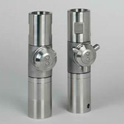 Two cylindrical metal lock cylinders standing upright on a plain gray background, with keyholes on their lower halves and screw holes at their bases.