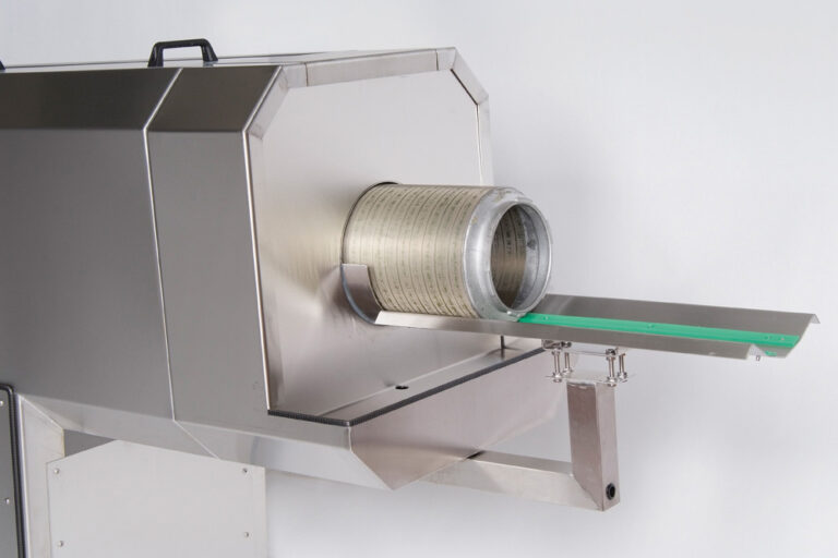 A stainless steel industrial machine with a cylindrical drum and a horizontal output tray. the device is mounted on a wall and features a simple mechanical design.
.
