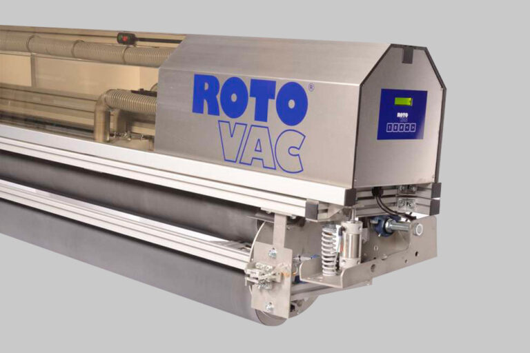 Industrial roto vac machine with a metallic body and electronic display, installed on a rail system for precision movement.