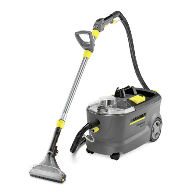 A Spray Extraction Cleaner Puzzi 8/1 C (Copy) featuring a long, adjustable handle with a trigger and a wide cleaning head. The machine has a transparent water tank, a hose connecting to the handle, wheels for mobility, and grey and yellow accents.